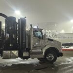 Industrial specialty services: Using a vacuum truck to remove oil and debris from an airport luggage beltway trench.