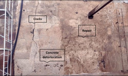 Abrasive media blasting uncovered numerous deteriorating layers of concrete, structural wall cracks, exposed and corroded structural rebar, and earlier repair patches.